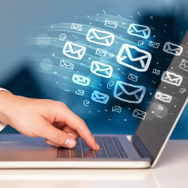 someone clicking on a laptop and sending e-mails
