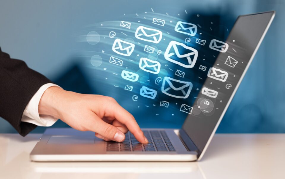 someone clicking on a laptop and sending e-mails